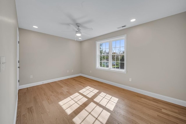 empty room with baseboards, light wood-type flooring, ceiling fan, and recessed lighting