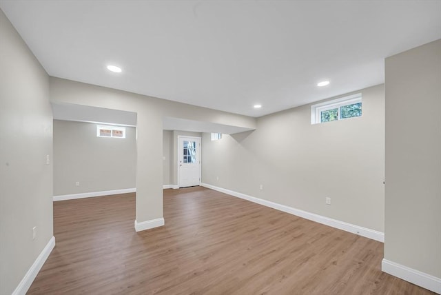 basement with wood finished floors, baseboards, and recessed lighting