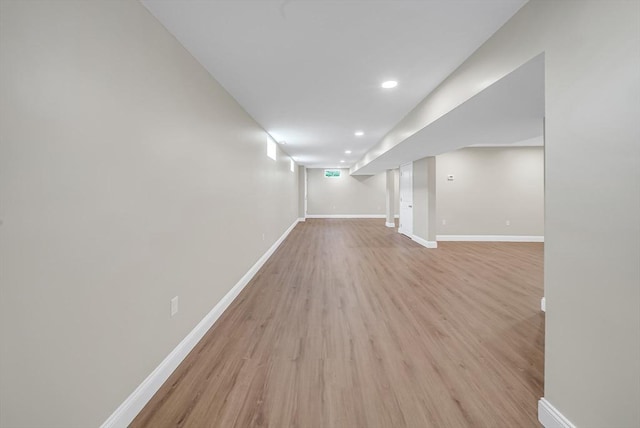 finished basement with light wood-style floors, baseboards, and recessed lighting