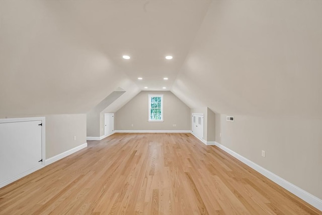 bonus room with baseboards, lofted ceiling, recessed lighting, and light wood-style flooring
