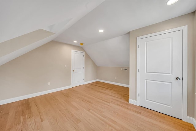 bonus room with baseboards, light wood-style flooring, vaulted ceiling, and recessed lighting