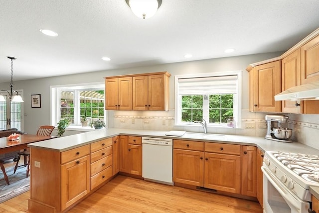 167 Orchard Rd, East Longmeadow, MA 01028 - kitchen featuring white appliances, a sink, light wood-type flooring, a peninsula, and tasteful backsplash