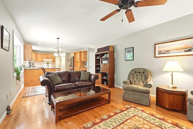167 Orchard Rd, East Longmeadow, MA 01028 - living area featuring light wood finished floors, a ceiling fan, baseboards, and a chandelier