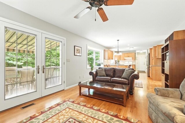 167 Orchard Rd, East Longmeadow, MA 01028 - living room with light wood finished floors, french doors, ceiling fan, and baseboards