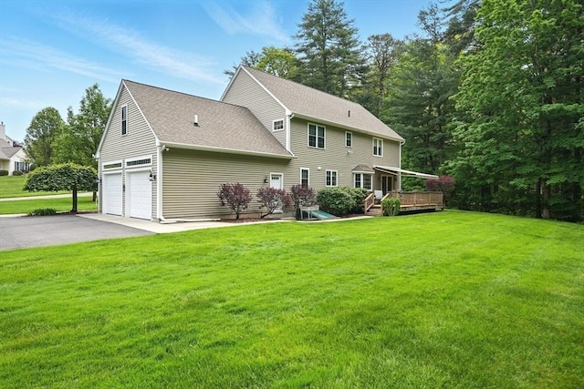 167 Orchard Rd, East Longmeadow, MA 01028 - rear view of house featuring a deck, driveway, a shingled roof, a yard, and an attached garage