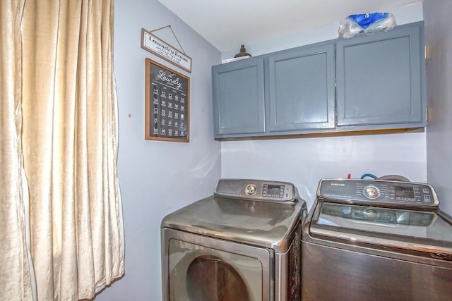 37 Border St, Springfield, MA 01104 - laundry area featuring washing machine and dryer and cabinet space