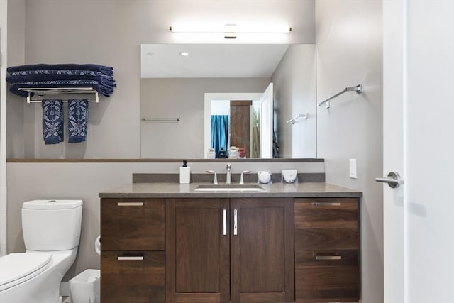 bathroom featuring toilet and vanity