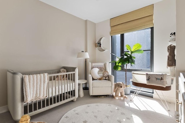 bedroom with a crib and carpet