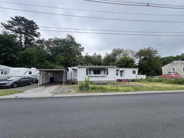 21 Worcester St, Taunton, MA 02780 - manufactured / mobile home featuring a carport, asphalt driveway, and view of wooded area