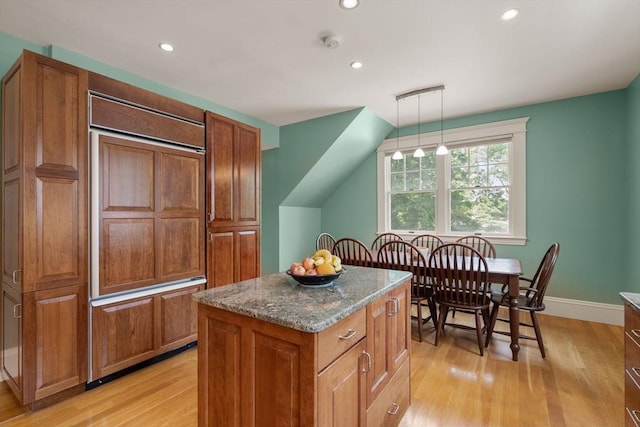 19 Woodbine St Unit B, Newton, MA 02466 - kitchen featuring light wood finished floors, a kitchen island, paneled built in fridge, recessed lighting, and brown cabinets
