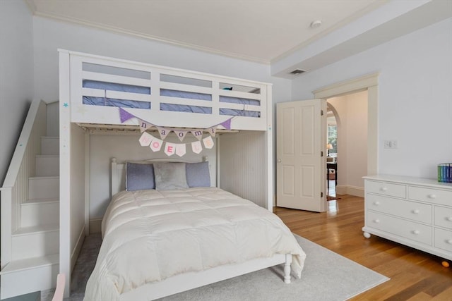 19 Woodbine St Unit B, Newton, MA 02466 - bedroom with wood finished floors, arched walkways, ornamental molding, and baseboards