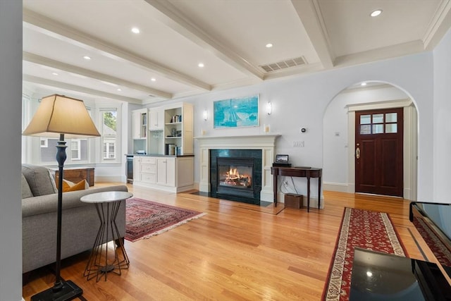 19 Woodbine St Unit B, Newton, MA 02466 - living room with arched walkways, light wood finished floors, beamed ceiling, a tile fireplace, and recessed lighting