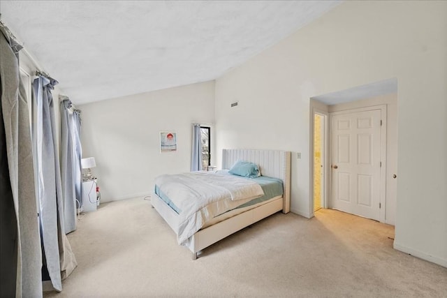 carpeted bedroom with baseboards and lofted ceiling