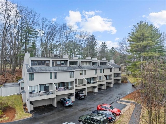 view of building exterior featuring uncovered parking