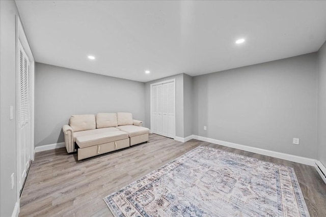 sitting room featuring baseboards, recessed lighting, and wood finished floors