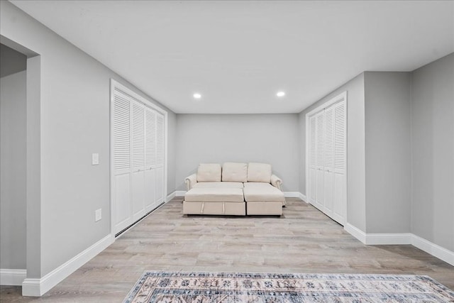 living area featuring recessed lighting, baseboards, and wood finished floors