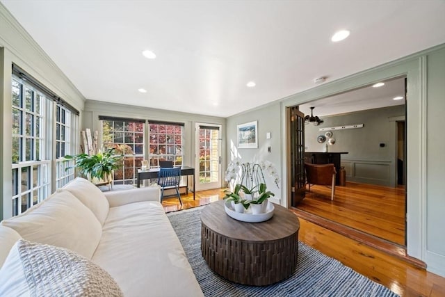46 Church St, Dedham, MA 02026 - living room with recessed lighting, wood finished floors, and a decorative wall