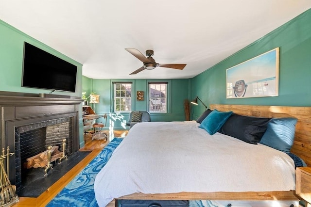 46 Church St, Dedham, MA 02026 - bedroom featuring a fireplace with flush hearth, a ceiling fan, and wood finished floors