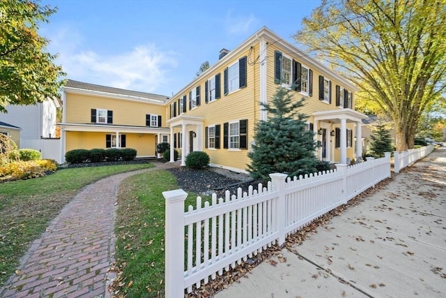 46 Church St, Dedham, MA 02026 - view of front facade with a fenced front yard and a chimney