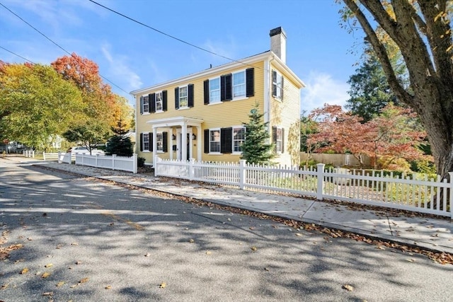 46 Church St, Dedham, MA 02026 - colonial house with a fenced front yard and a chimney