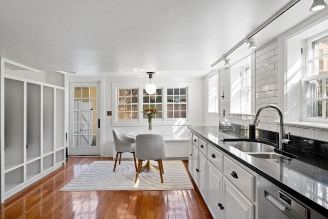 46 Church St, Dedham, MA 02026 - kitchen with dark stone countertops, dark wood-style floors, a sink, dishwasher, and tasteful backsplash
