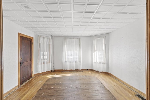 empty room with light hardwood / wood-style flooring