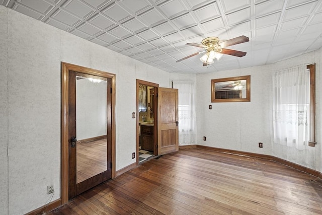 unfurnished room with ceiling fan and wood-type flooring