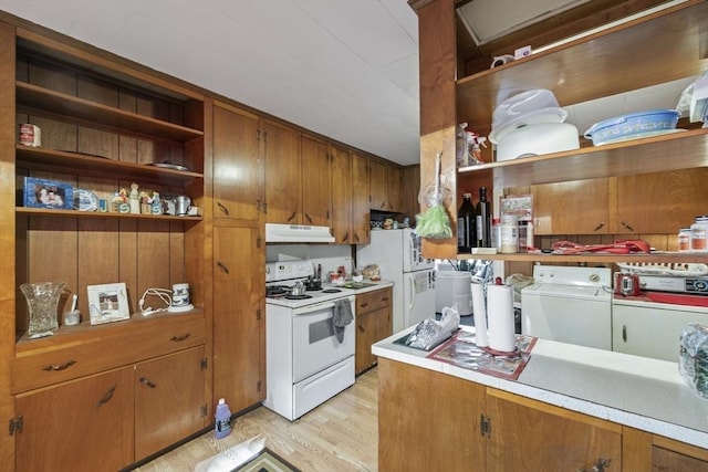 kitchen featuring built in shelves, white appliances, separate washer and dryer, and light hardwood / wood-style flooring