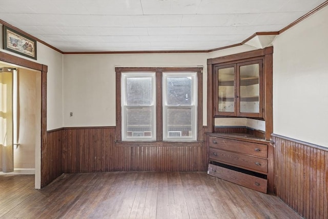 spare room featuring dark wood-type flooring and ornamental molding