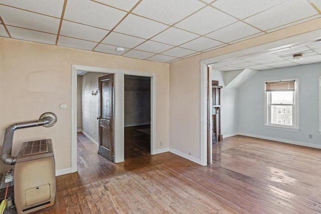 interior space featuring hardwood / wood-style floors and a drop ceiling