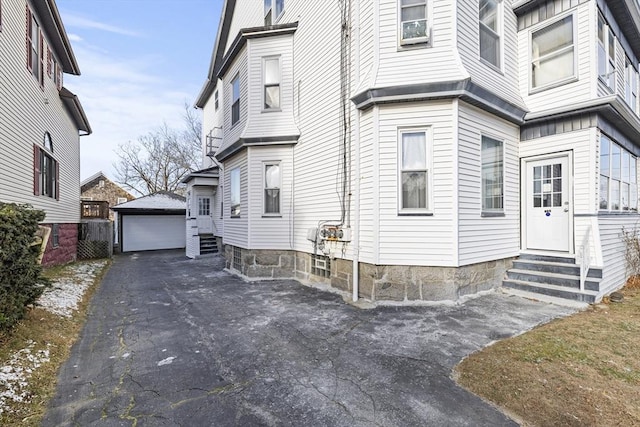 view of home's exterior with a garage and an outdoor structure