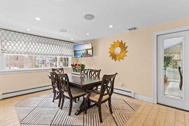 dining space with a baseboard radiator, visible vents, light wood-style flooring, and recessed lighting