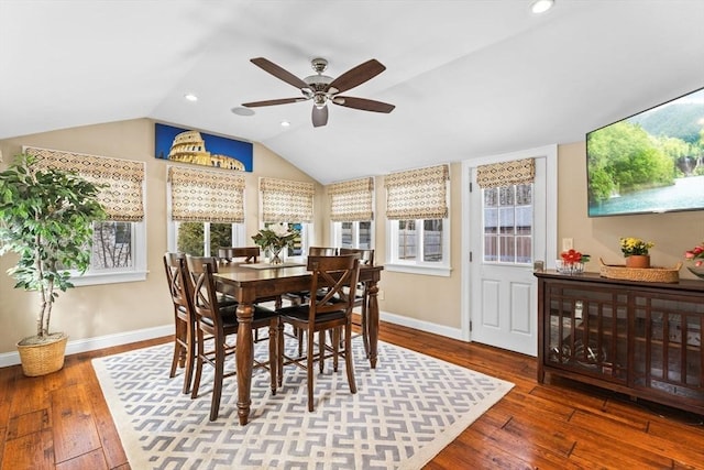 dining area featuring baseboards, vaulted ceiling, and hardwood / wood-style floors