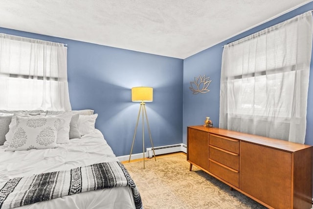 bedroom featuring a baseboard heating unit and baseboards