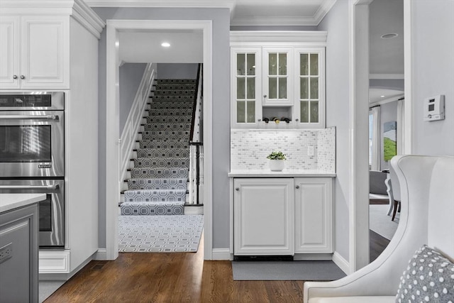 interior space featuring hardwood / wood-style flooring and crown molding