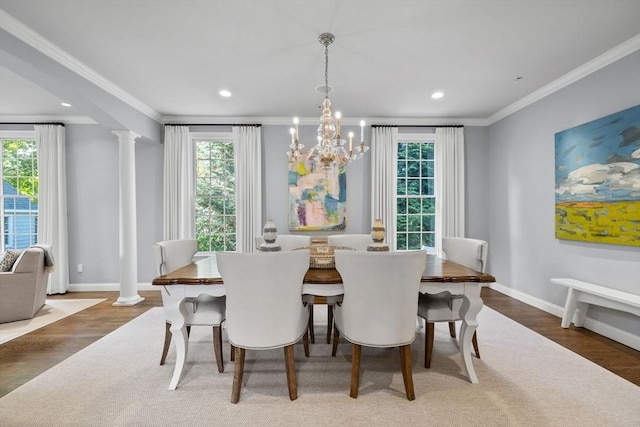 dining space with ornamental molding, dark hardwood / wood-style flooring, and ornate columns