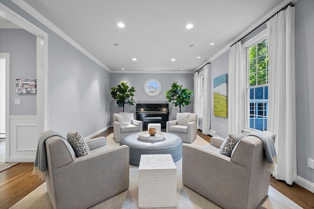 living room with crown molding and light hardwood / wood-style floors