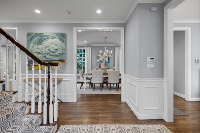 entryway featuring a chandelier, ornamental molding, and dark hardwood / wood-style flooring