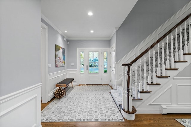 entrance foyer featuring light wood-type flooring and crown molding