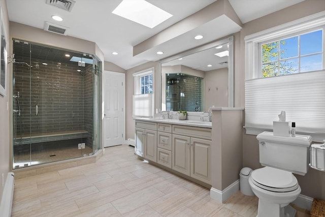 bathroom featuring vanity, toilet, a baseboard heating unit, and a shower with door