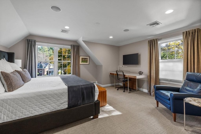 bedroom with multiple windows, light colored carpet, and lofted ceiling