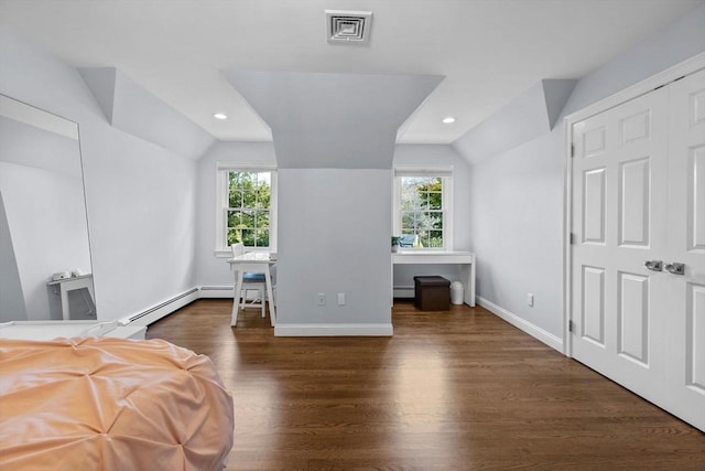 bedroom with multiple windows, dark wood-type flooring, and lofted ceiling