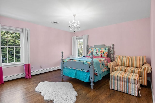 bedroom with baseboard heating, dark hardwood / wood-style flooring, and an inviting chandelier