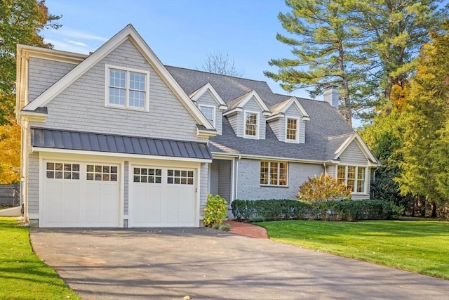 view of front of house featuring a garage and a front lawn