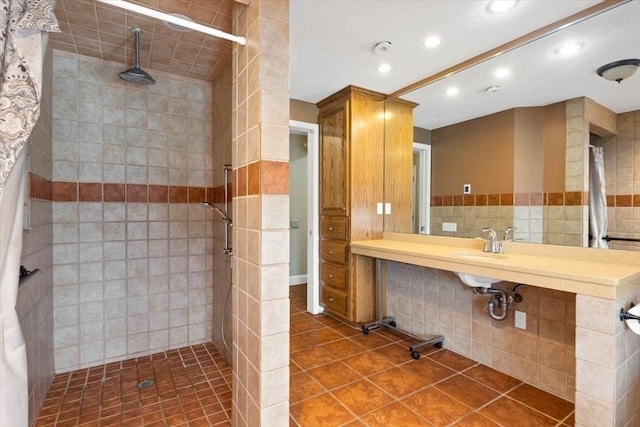 bathroom with tile patterned floors, tile walls, and a tile shower