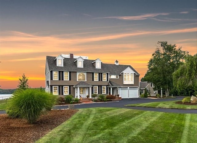 view of front of home featuring a garage and a yard