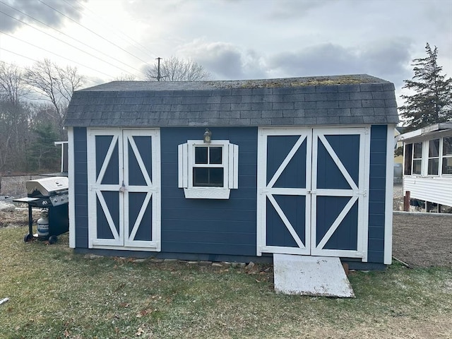 view of outbuilding featuring a yard