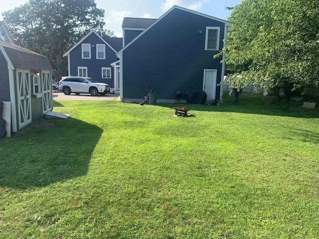 view of yard with a storage shed and an outbuilding