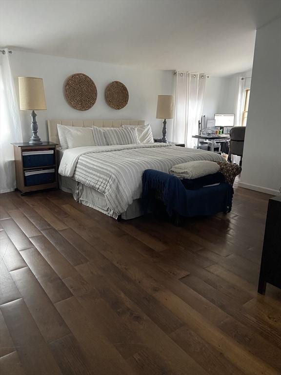 bedroom with dark wood-type flooring