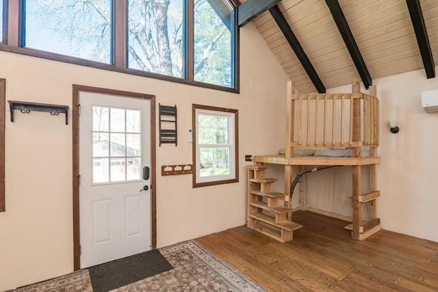 doorway to outside with wood ceiling, beam ceiling, a wall mounted air conditioner, wood finished floors, and high vaulted ceiling